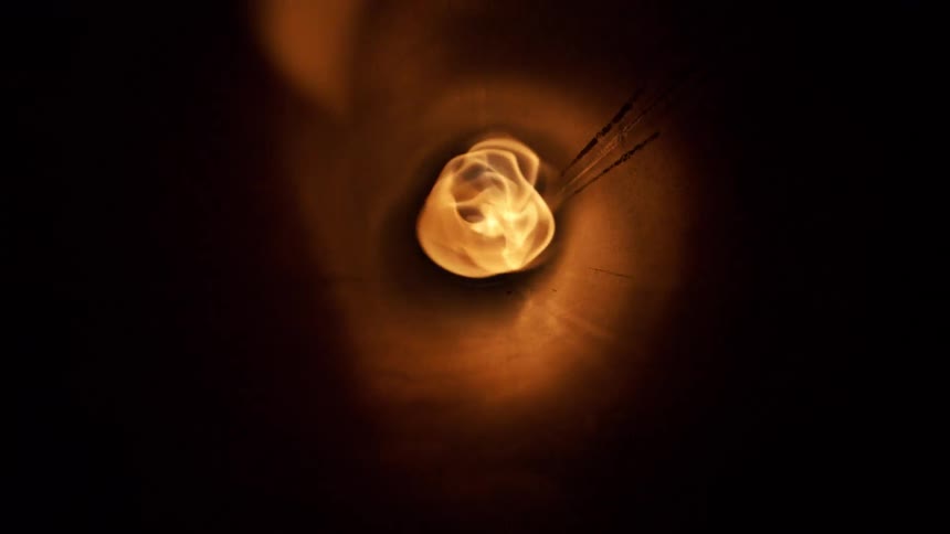 Flame viewed through the inside of a dark tube