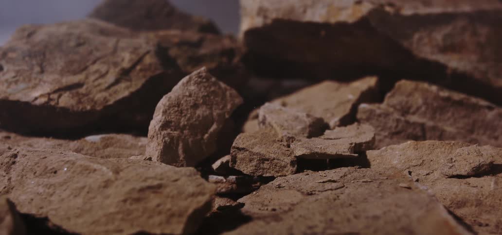 A rock splash with a series of rocks shattering on impact under a sunny day
