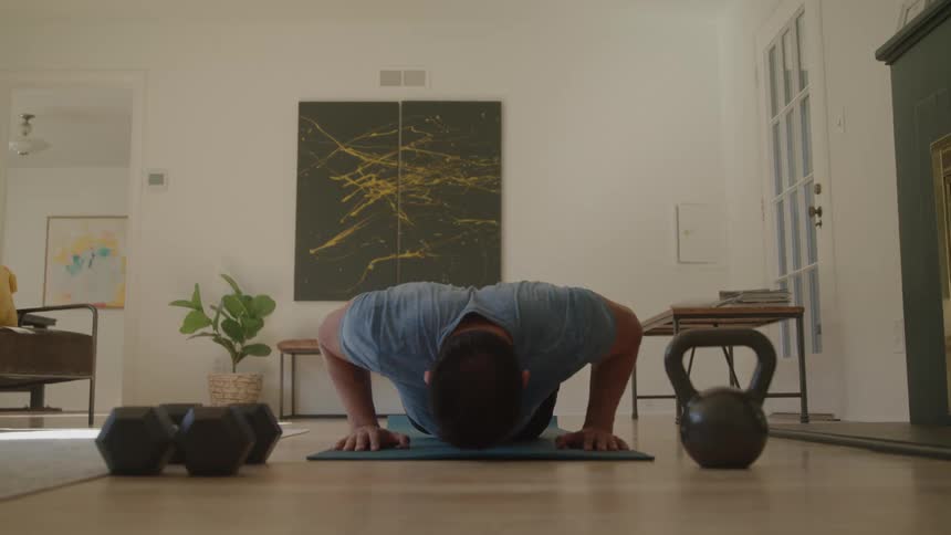 Man doing pushups indoors