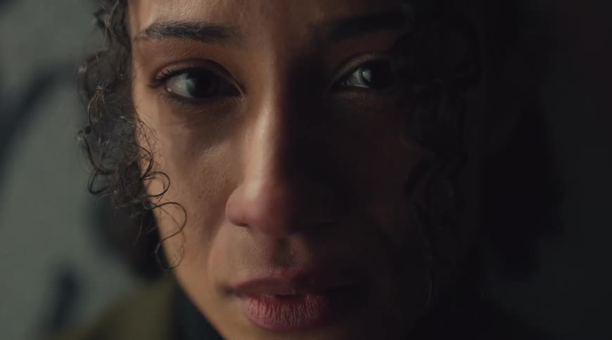 Closeup of a teary eyed woman moving to look toward the side