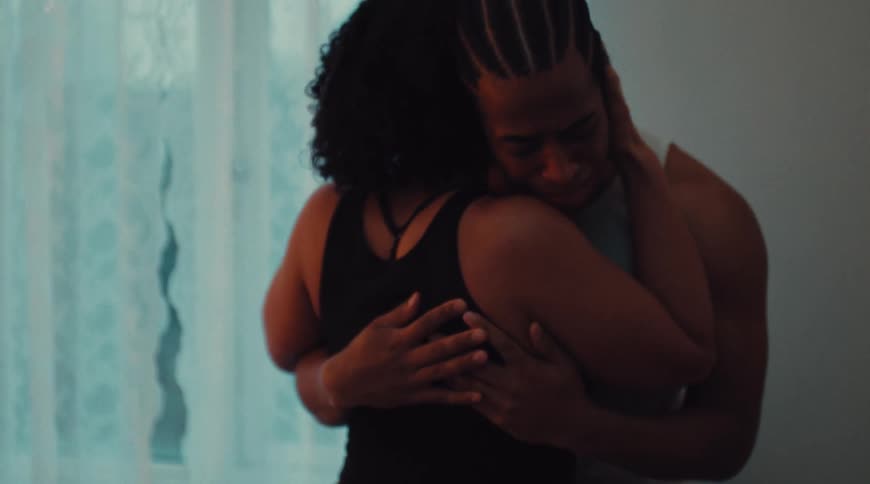 Woman hugs and consoles crying man