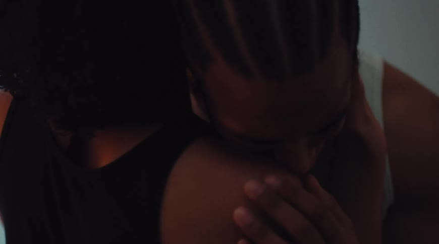 A couple share a warm intimate moment indoors
