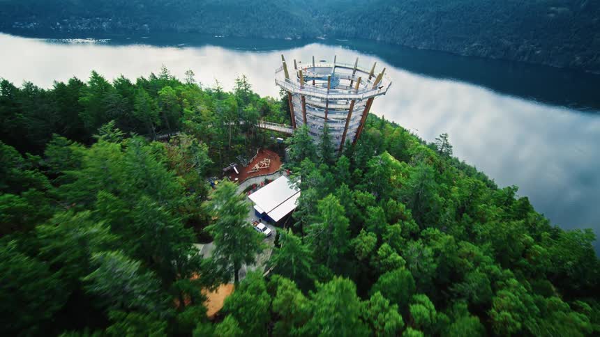 A tourist site in a forest surrounded by a lake in the wilderness
