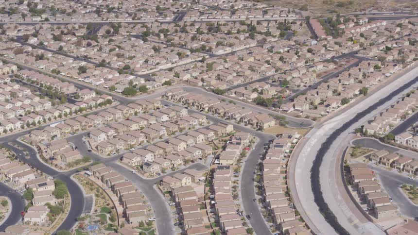 Aerial view of a residential neighborhood with curved streets and uniform houses