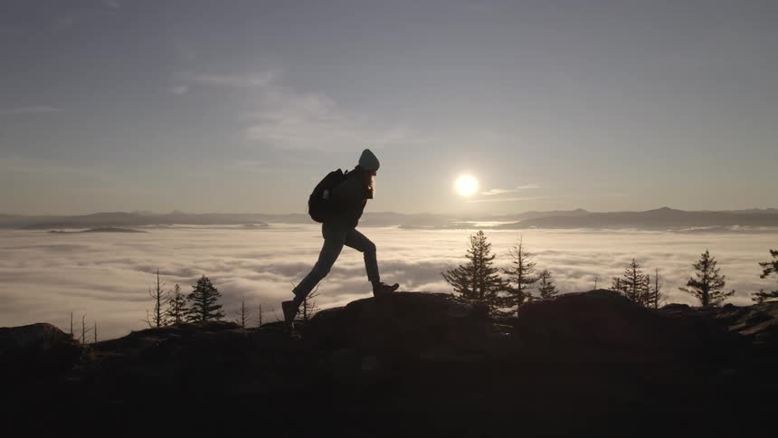 A girl hikes along the rocks