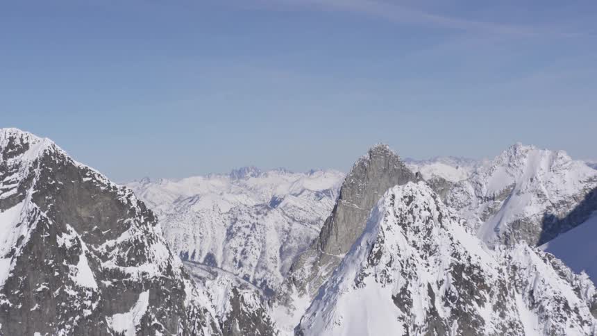 Snowcovered mountain peaks under a clear blue sky