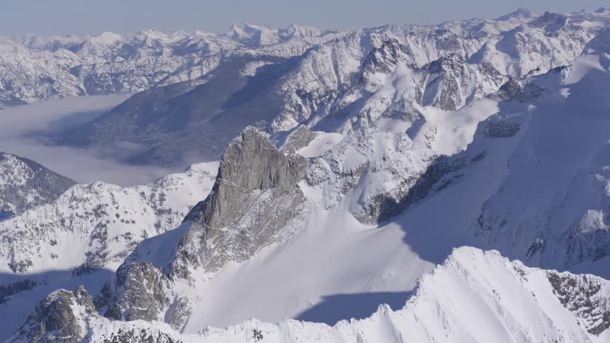 A rugged snowcovered mountain range on a sunny winter day