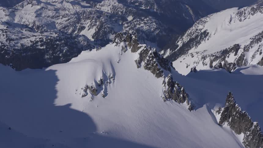 A mountain range covered in snow on a winter day