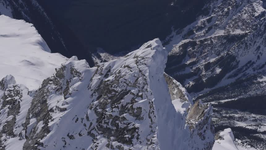 Snow covered mountain peaks in a dramatic aerial shot