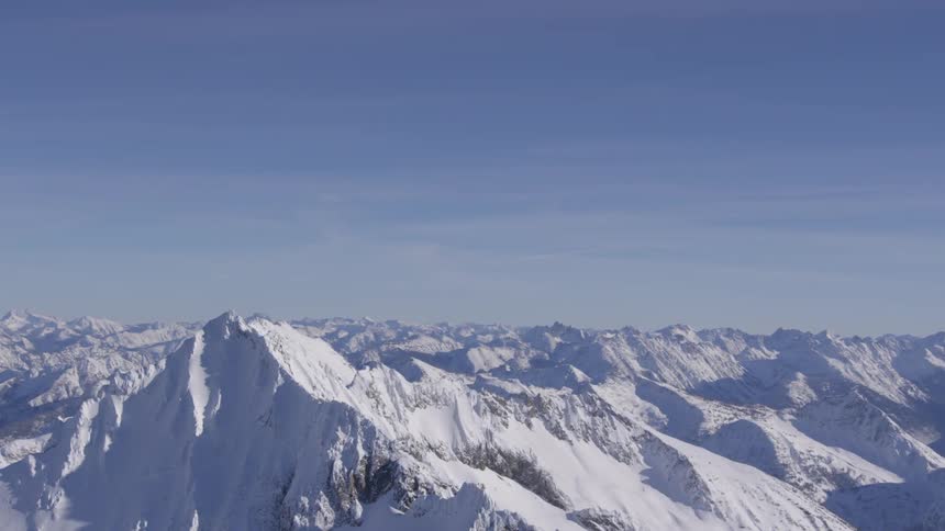 The mountain range is covered in snow on the landscape