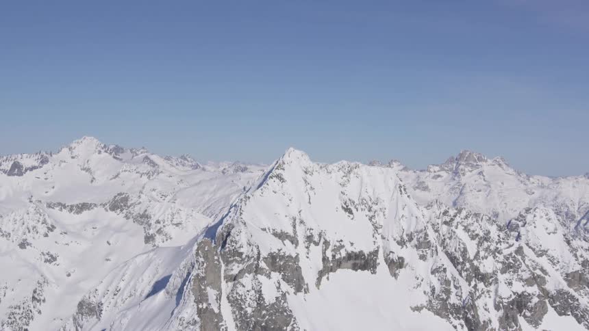 Peak of a snowcovered mountain at midday