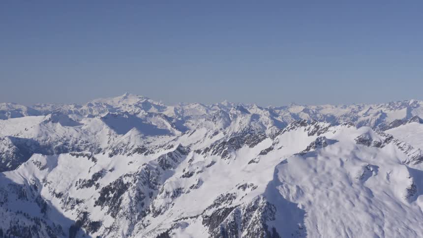 Snow covered mountains with rough terrain across the landscape