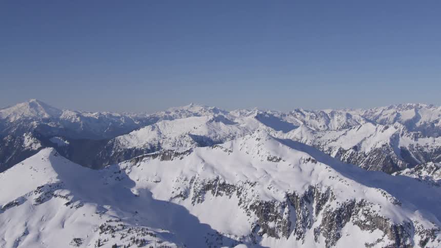 A mountain range covered in snow on a winter day
