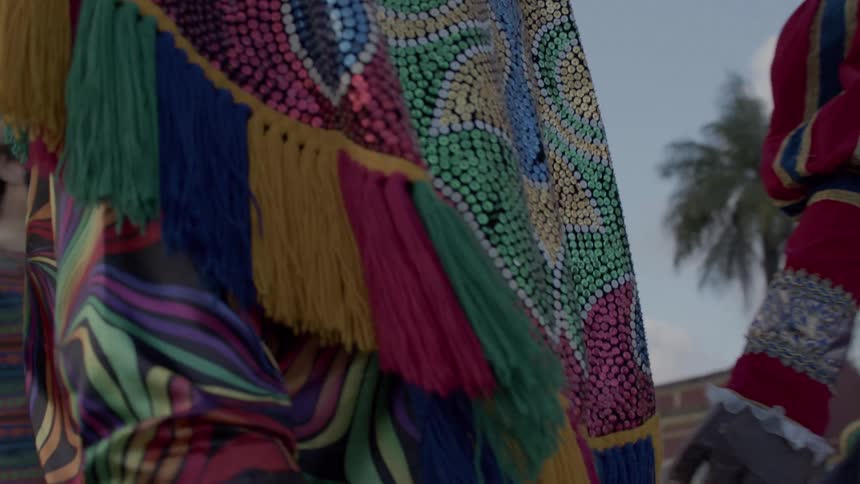 Colorful costumes with embroidery and shiny details worn in a cultural performance