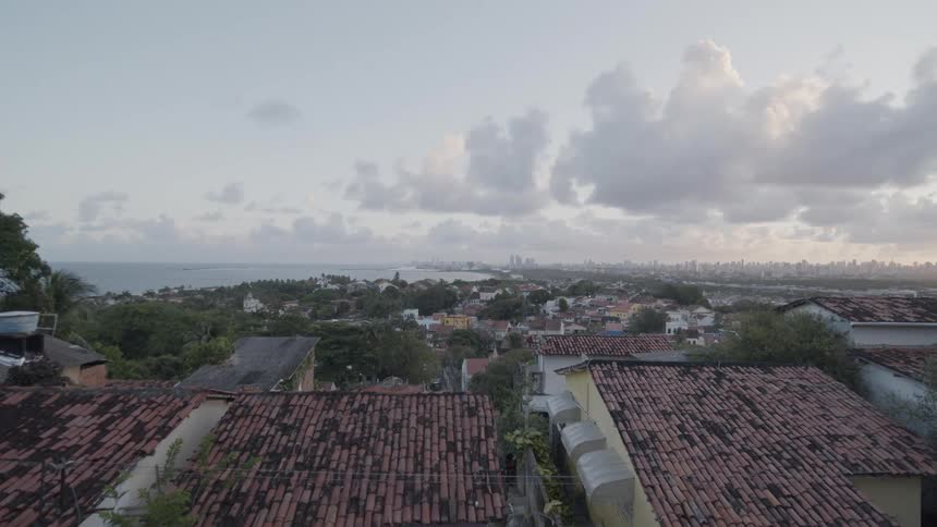 Man in a cap looks at the urban landscape and the sea from a decorated viewpoint