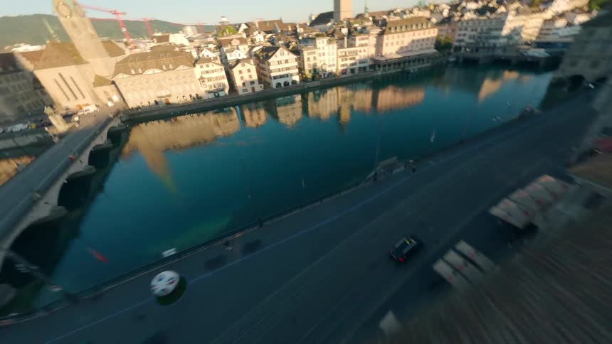 FPV drone flies over the Grossmünster in Zurich, descends towards the Limmat, and ends with a big reveal of Lake Zurich