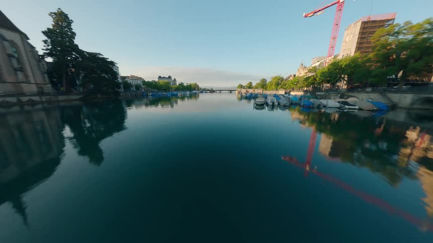 FPV clip of a historic european city with rooftops near a river