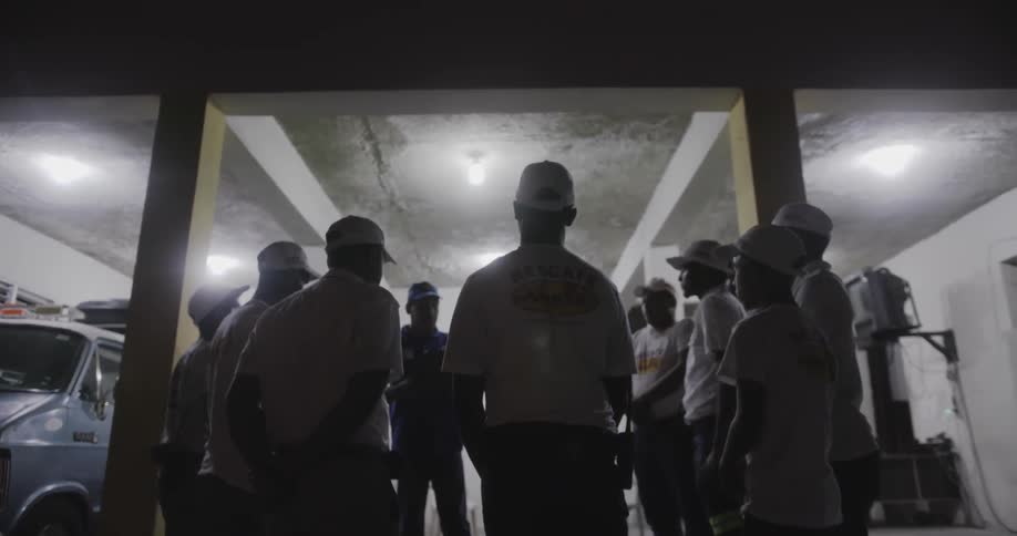 People are standing in a group together at night