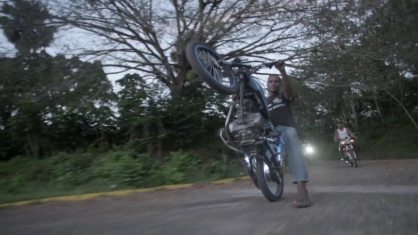 A Man Riding a Wheelie on a Motorcycle