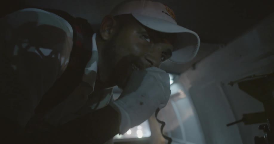 A man is using a radio while riding in the back of an ambulance