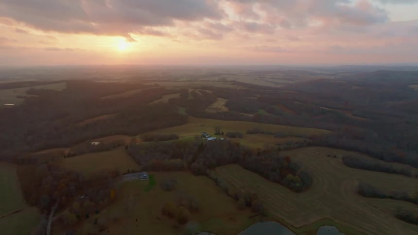 Aerial view of fields and forests at sunset