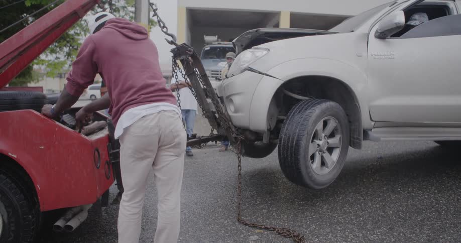 A truck is raised up by a tow truck