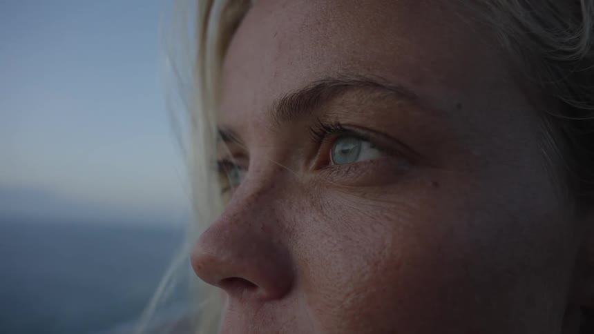 A young blonde woman outdoors on a beach