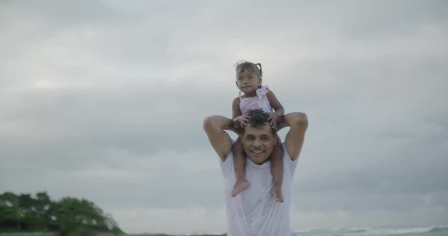 A man walks around with a child on his shoulders