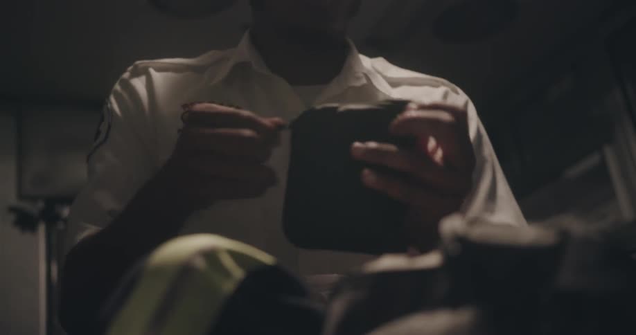 A paramedic looks through supplies