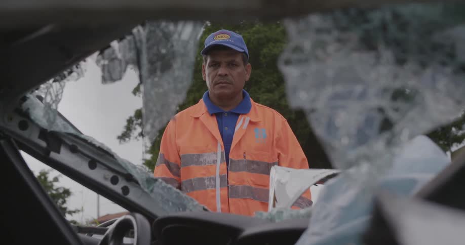 A Man Stares at a Wrecked Car
