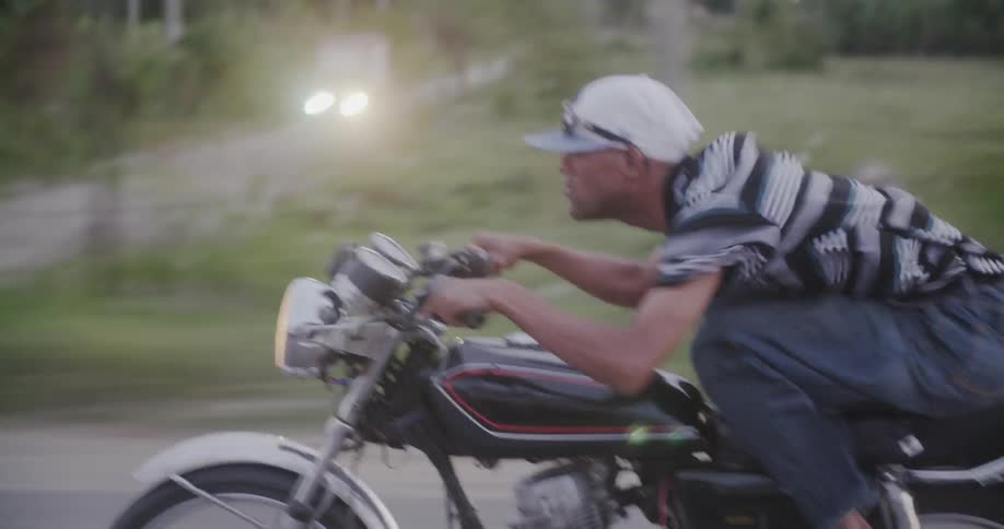Man riding very fast on a motorcycle through the country