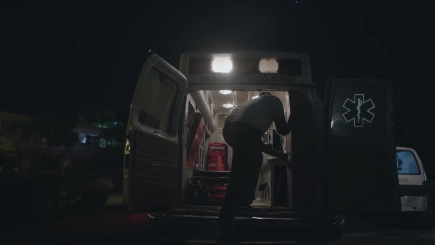 An emt checks the readiness of his ambulance