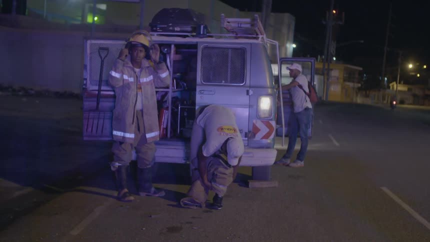 Emergency technicians suit up outside of a van