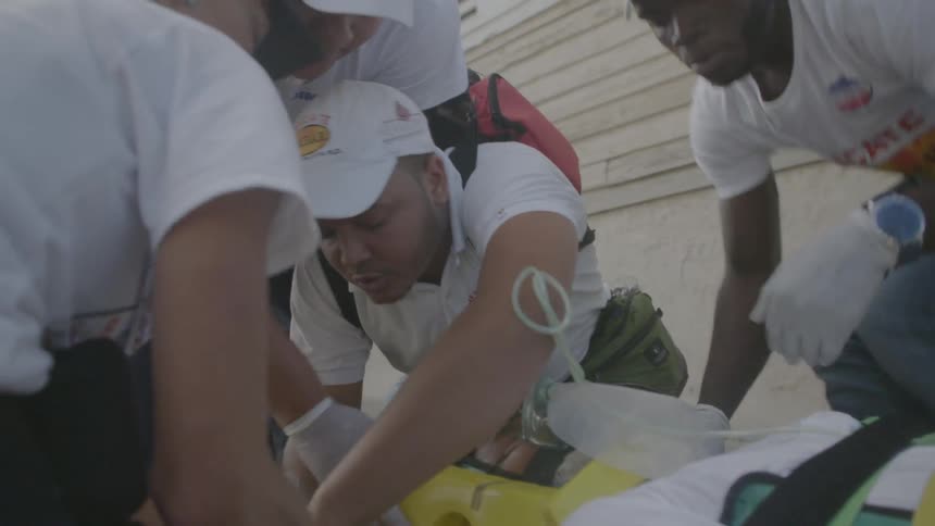Paramedics work on a patient