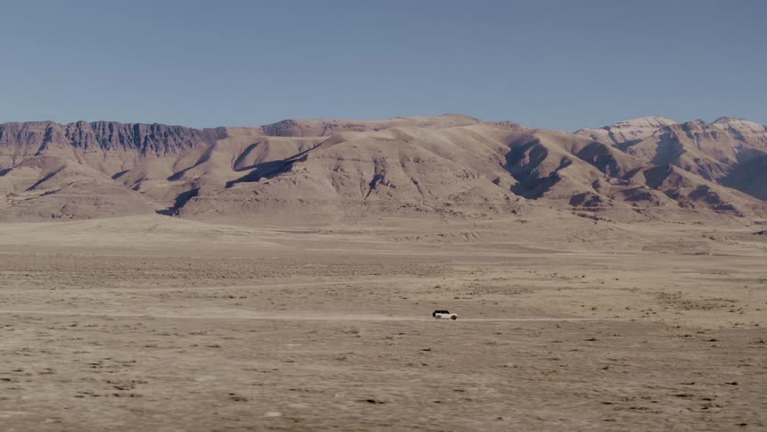 An suv crossing the dessert at high speed
