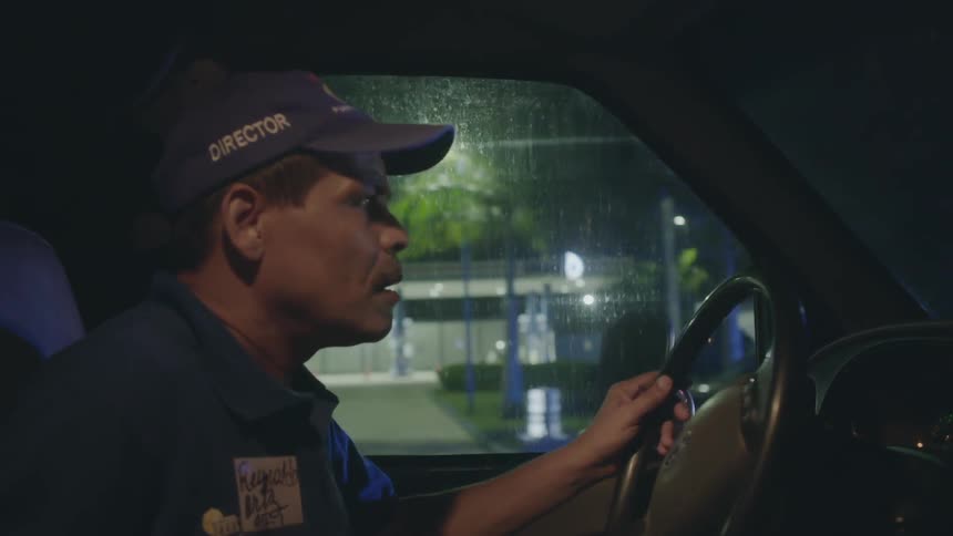 A man makes a turn in a car at night