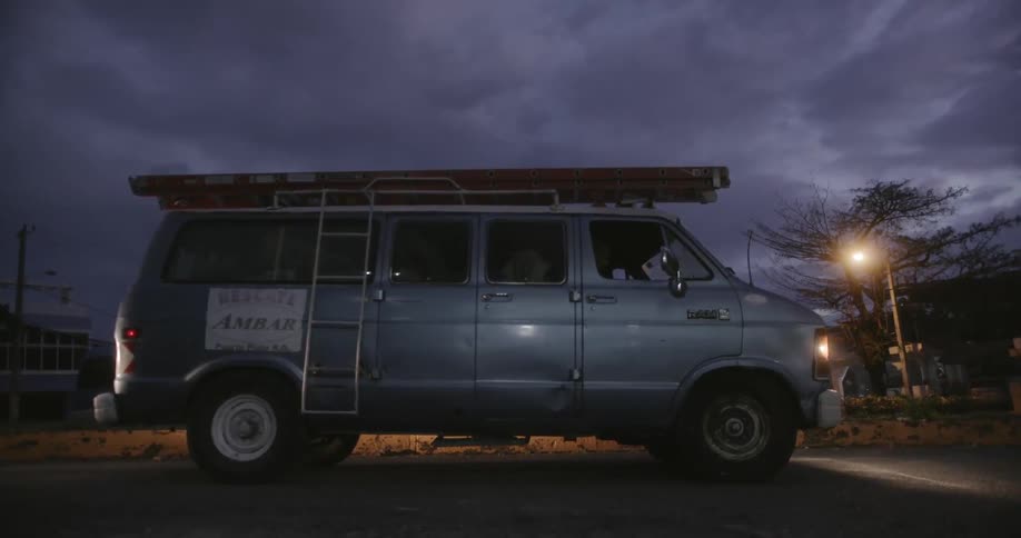 Flashing lights shine on a parked van