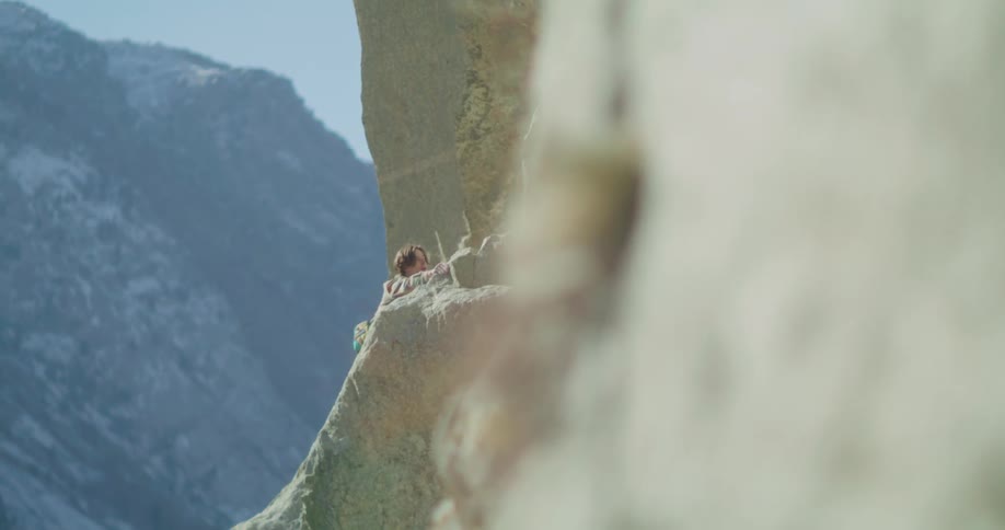 A person climbs a mountain cliff on an adventure
