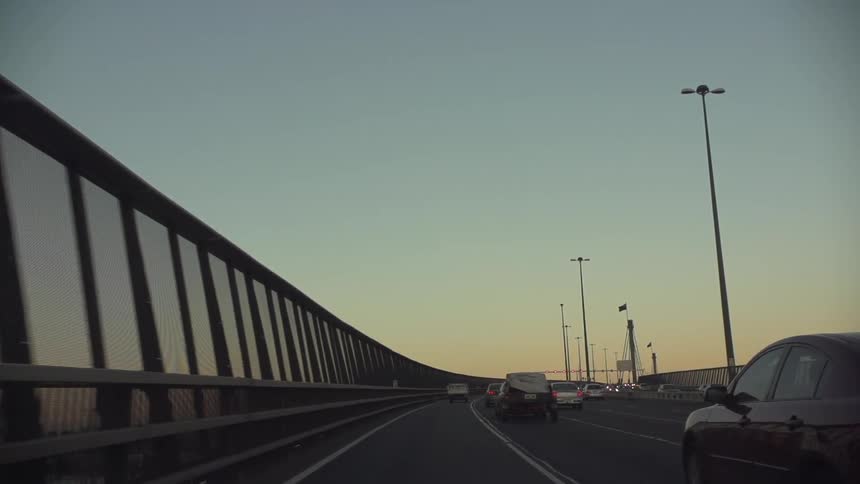 View of a road with many cars at sunset