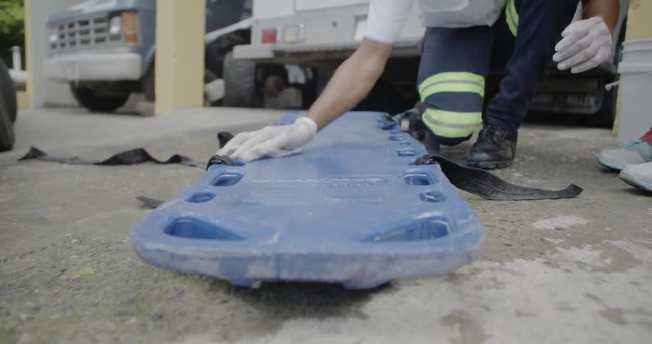 A paramedic wipes off his stretcher