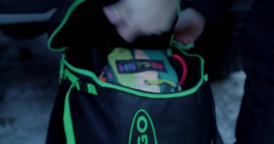 Man and a woman packing hiking gear into a backpack
