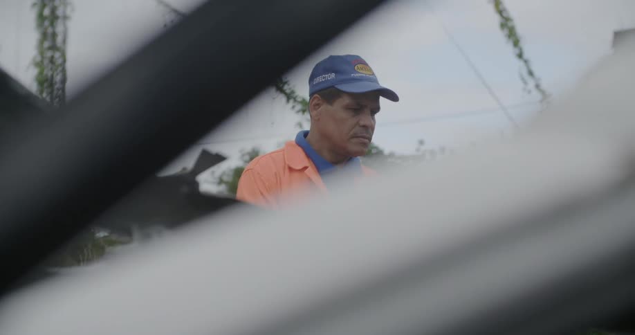 A man is looking at a wrecked vehicle