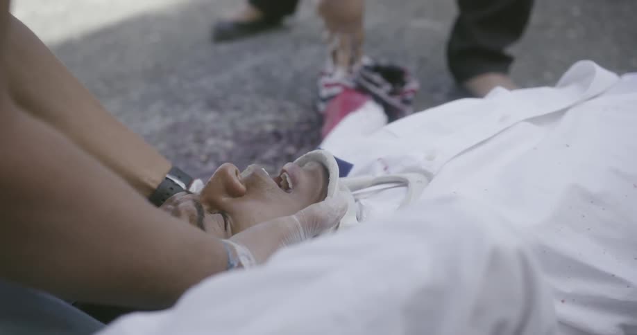 People tend to an injured man on the ground