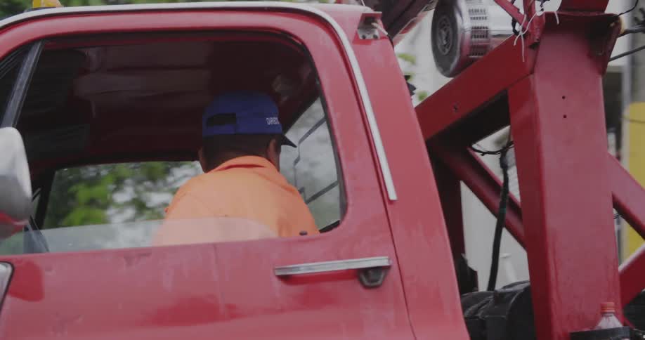Man backing up his tow truck to something
