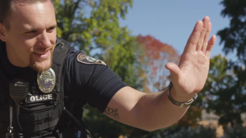 A police officer high fives a boy