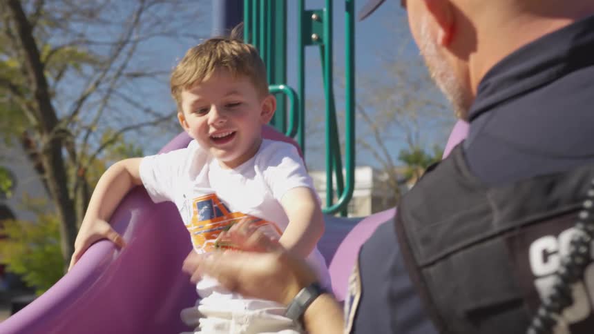 Boy slipping on a toy and hitting a police officers hands