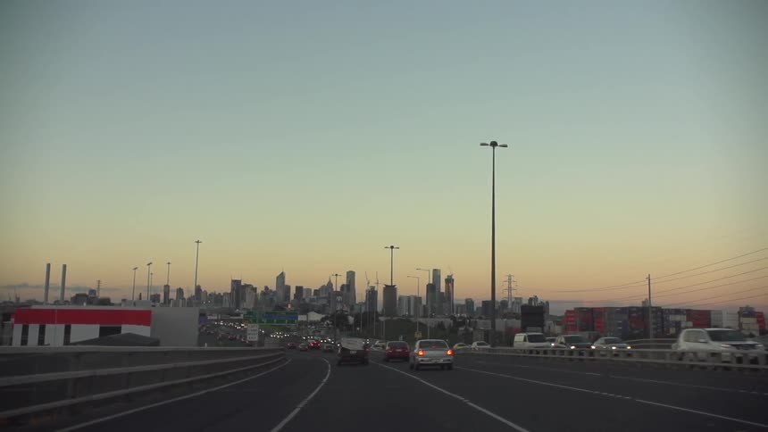 Busy freeway with city skyline off in the distance