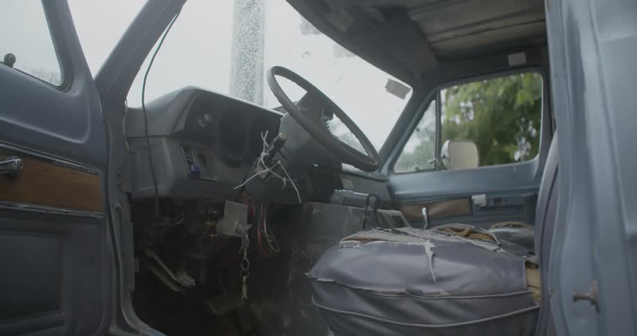 A worn out car interior is shown