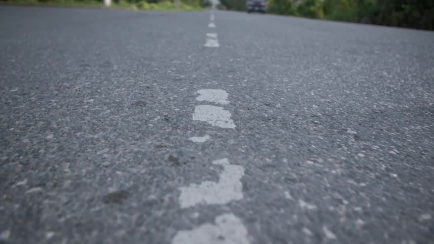 A street with a broken white line on it