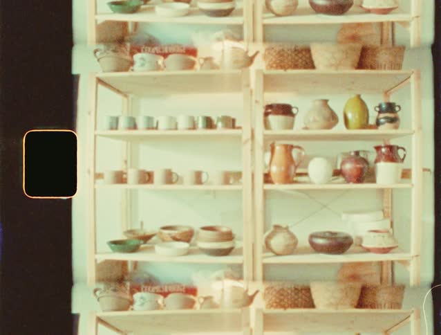 Cabinets with ceramic jugs and glasses and wicker baskets